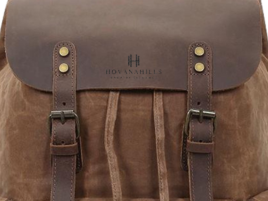 Close-up of Hovanahills waxed canvas, leather flap and brass buckles